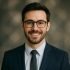 314393315-portrait-of-a-smiling-young-businessman-wearing-eyeglasses-and-looking-at-camera
